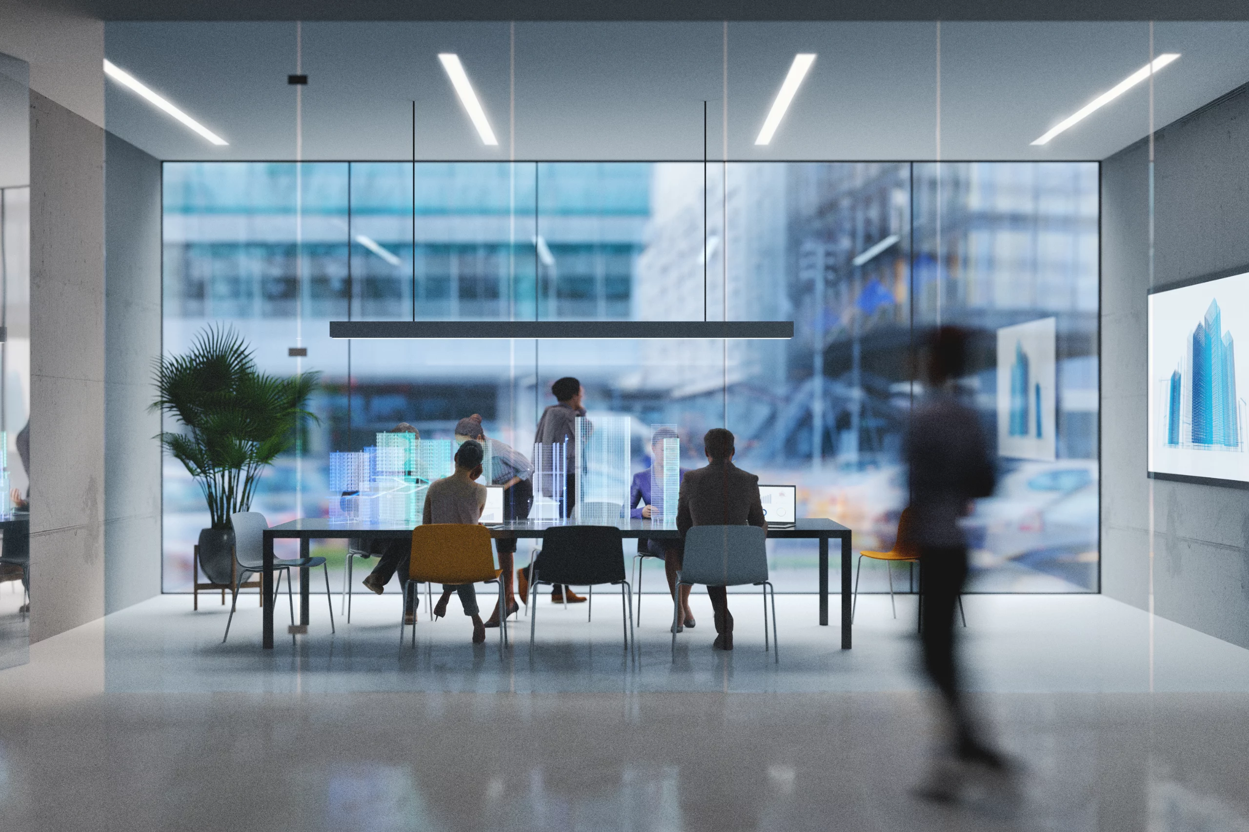 Long table in glass room with technology symbols and person walking by blurry