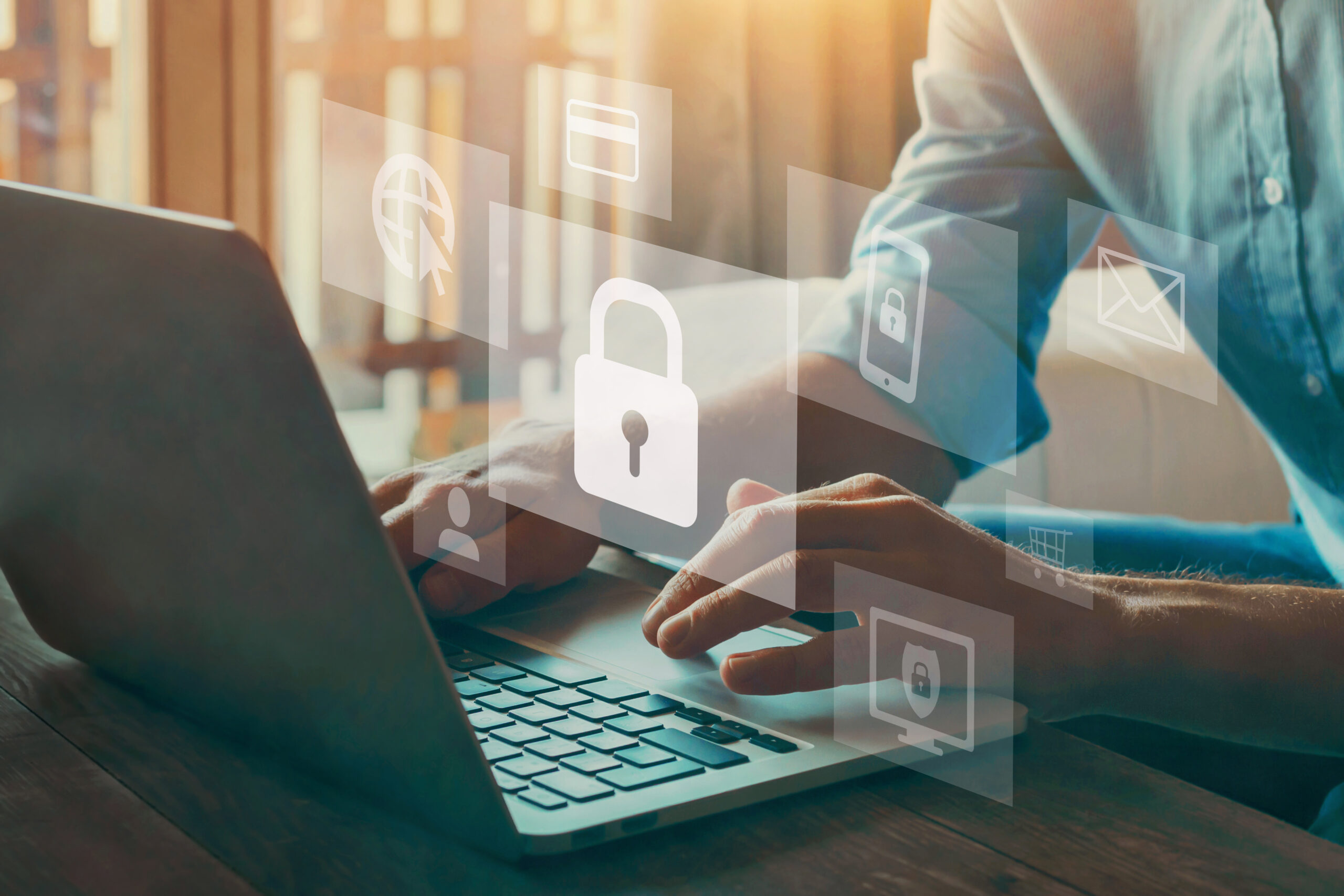 Man typing on laptop with data protected padlock icon
