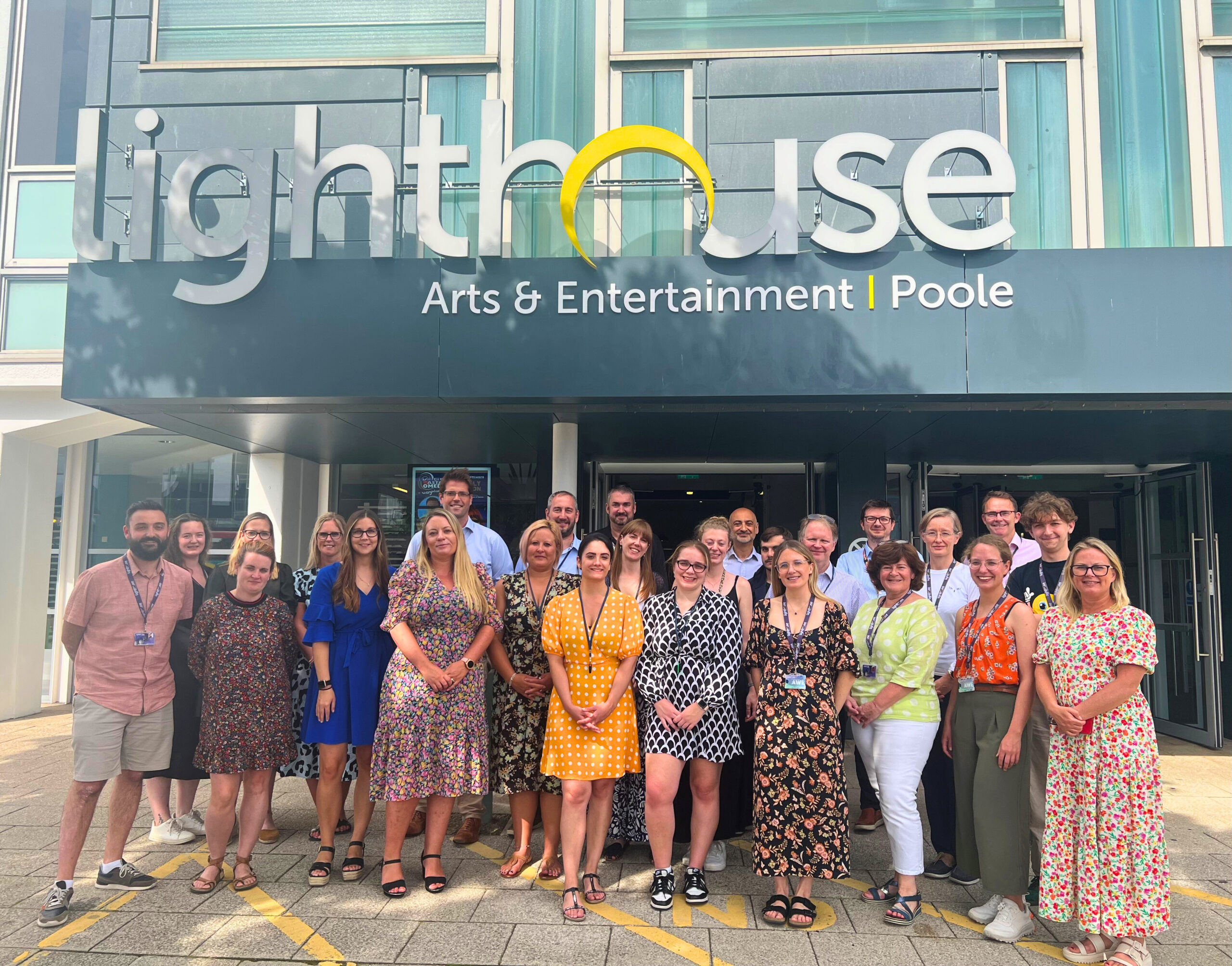 Poole office staff outside Poole's lighthouse