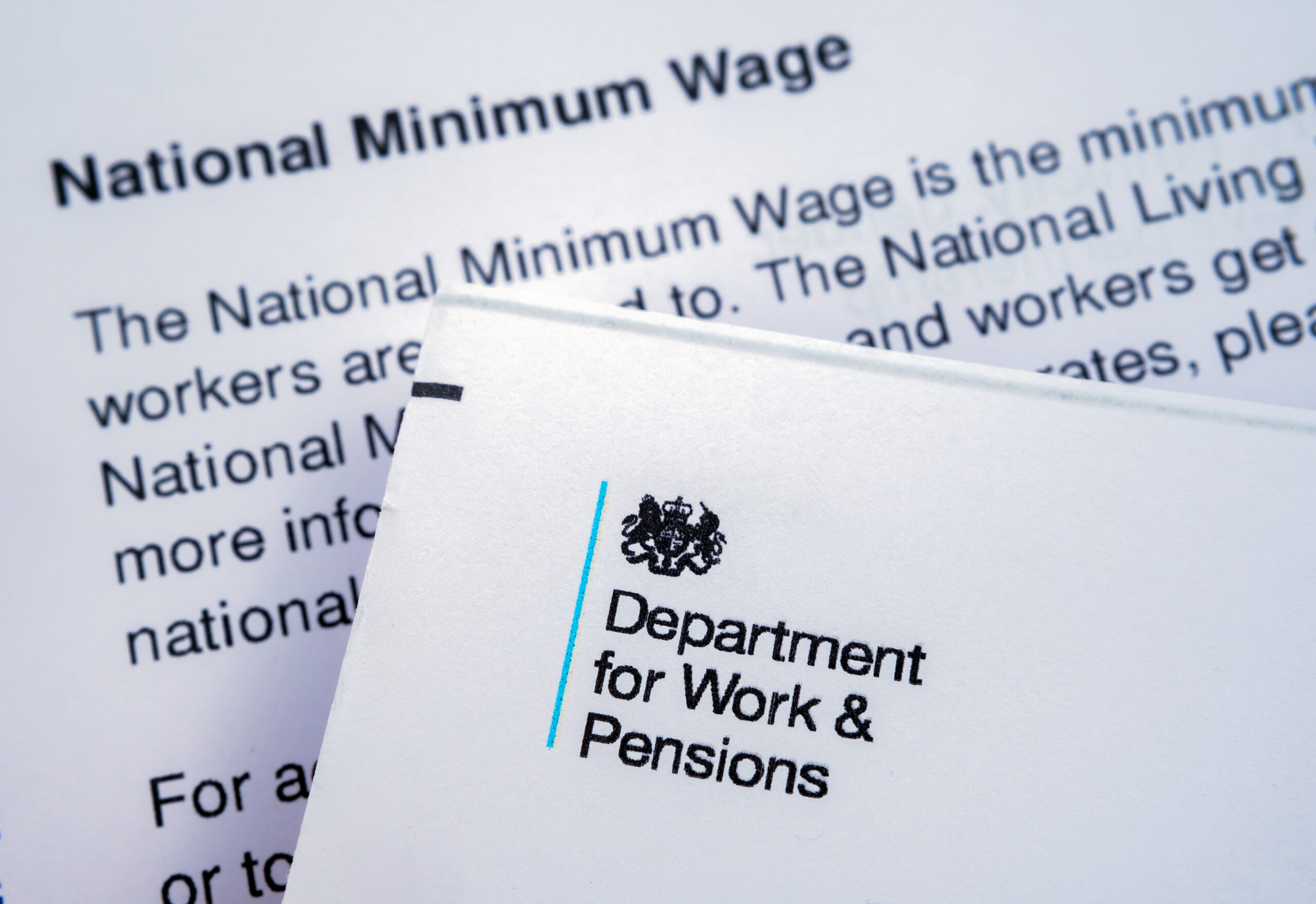 Genuine letter from UK Department for work and Pensions placed on top of letter about National insurance number and Minimum wage. Stafford, United Kingdom, May 29, 2022