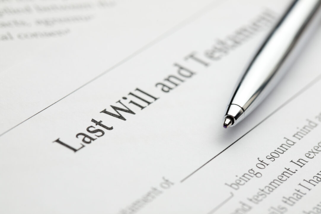 A blank last will and testament form with a pen laying over it.