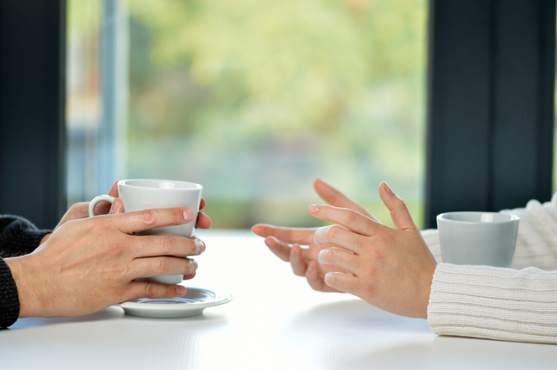 Hands of friends with cups and time for a coffee break