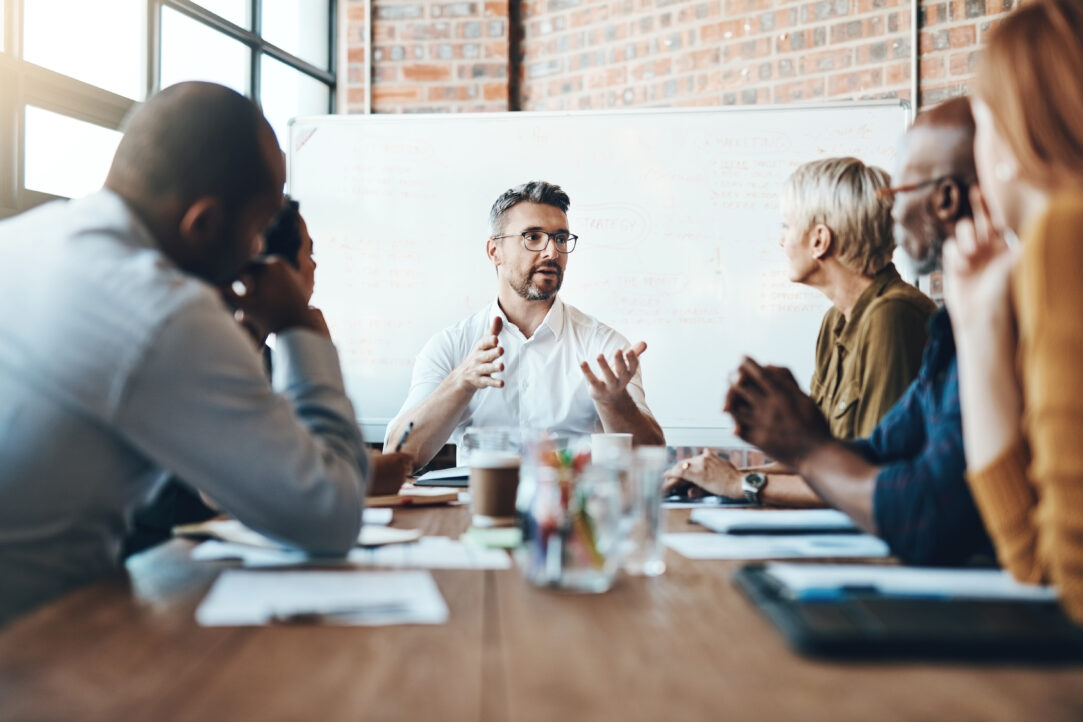 Shot of a businessman leading a meeting in the boardroom of six people
