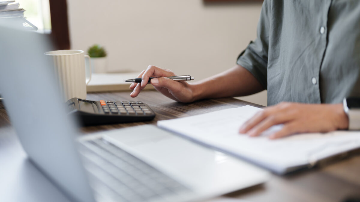 Female calculating personal financial for future plan at her home, taxes payment