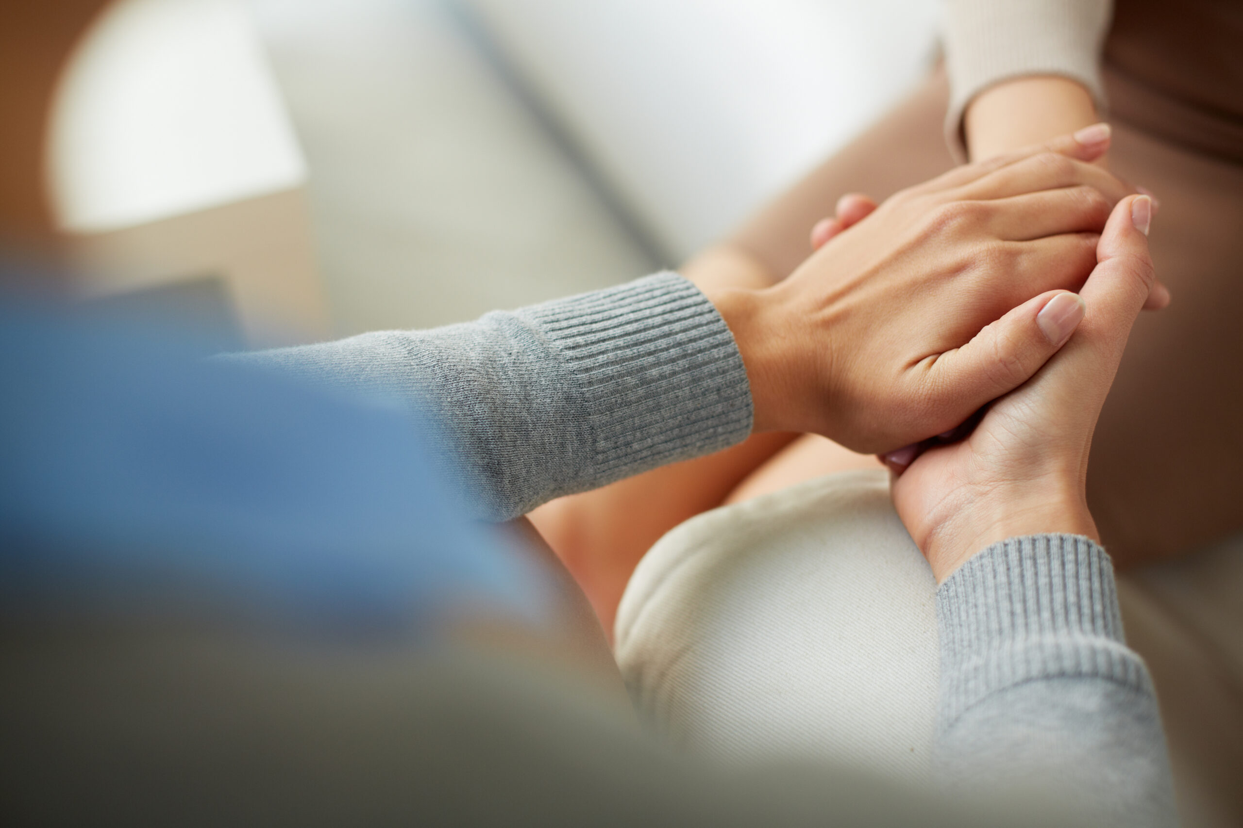 People holding hands in a caring way
