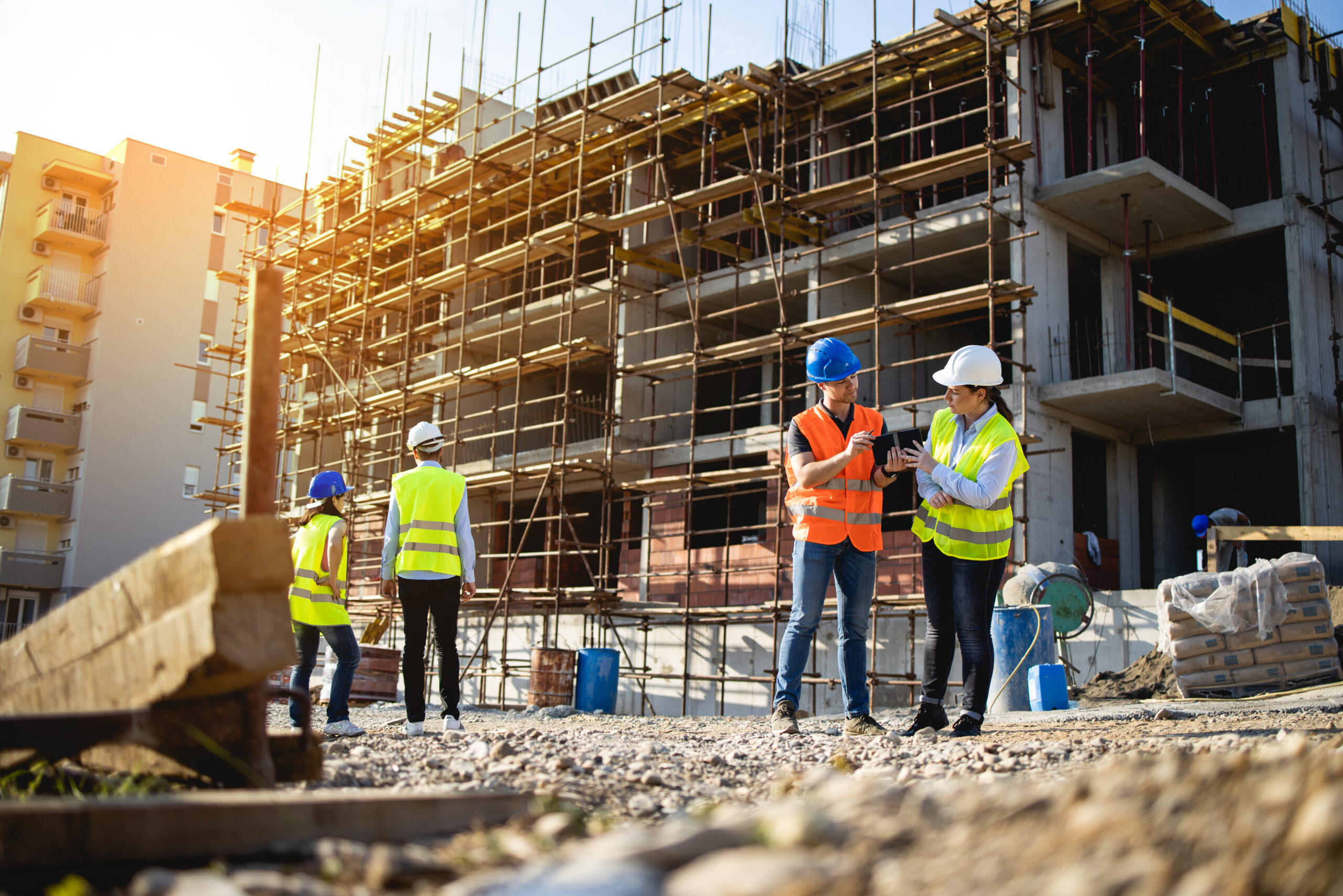 Four construction workers having meeting