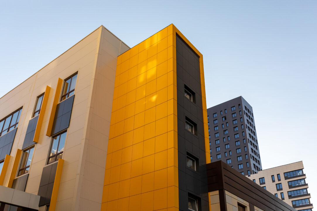 Yellow-brown modern ventilated facade. Modern facades of high-rise buildings or large residential complexs.