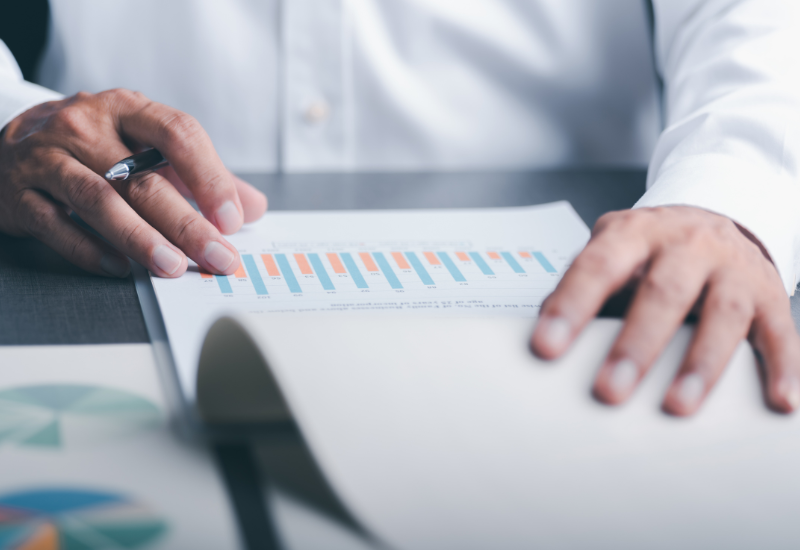 Man looking over graph document