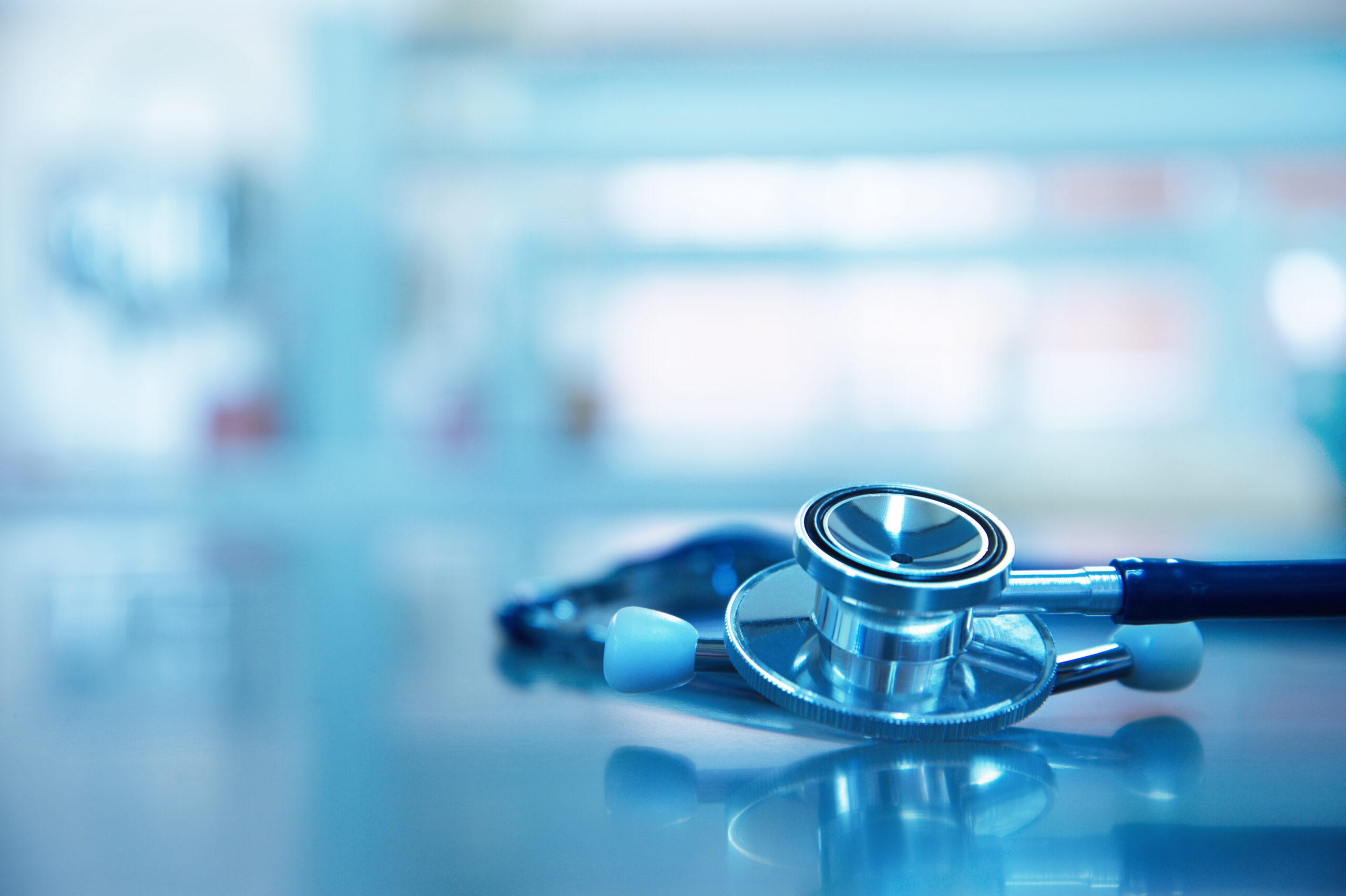 stethoscope for medical doctor cardiology diagnosis on blue health science laboratory background