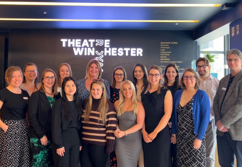 A group picture of the Winchester team with Play The Crowd staff in the theatre reception