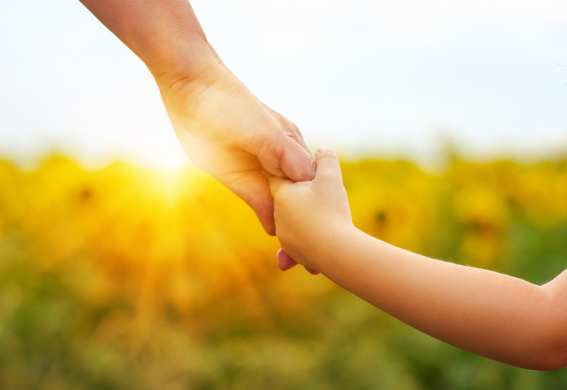 parent holding hands with child