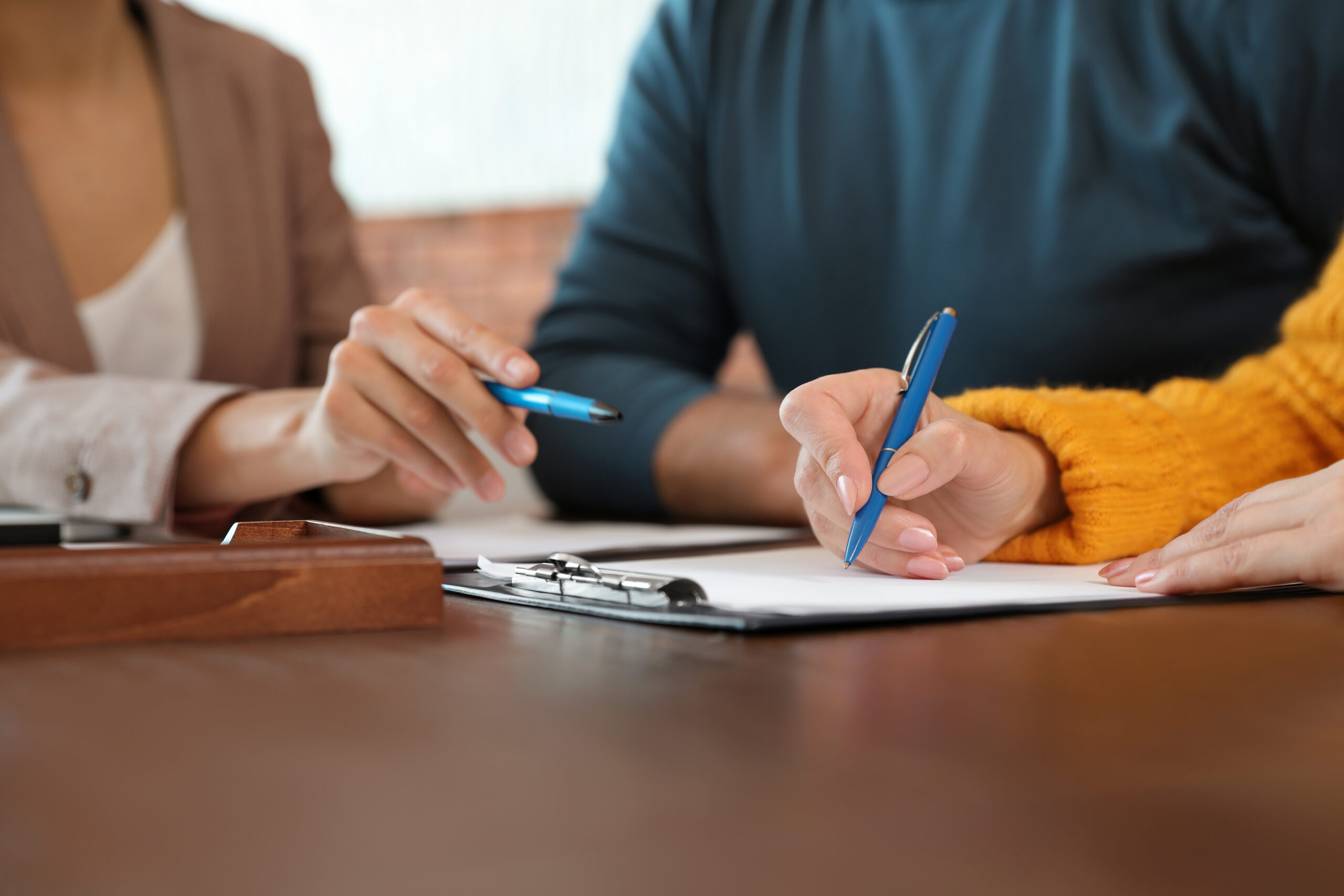 Female notary working with mature couple in office, closeup