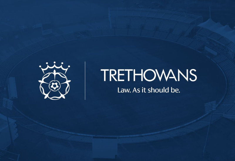 Image shows the Hampshire Cricket logo alongside the Trethowans logo, in light of their 2026 partnership. The background is a blue image of the Utilita Bowl stadium.